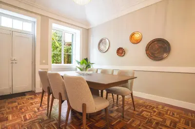 a dining room with a wooden table and chairs at Casa dos Francelhos by Atlantic Holiday in Funchal