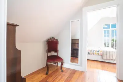 a chair sitting in a room with a bedroom at Casa dos Francelhos by Atlantic Holiday in Funchal