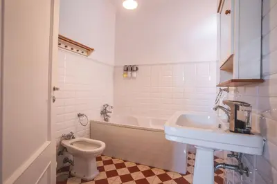 a bathroom with a tub and a toilet and a sink at Casa dos Francelhos by Atlantic Holiday in Funchal