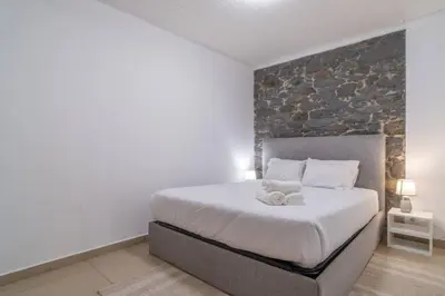 a bedroom with a bed with two towels on it at Atouguia Villa in Calheta