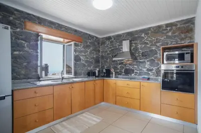 a living room with a white couch and a table at Atouguia Villa in Calheta