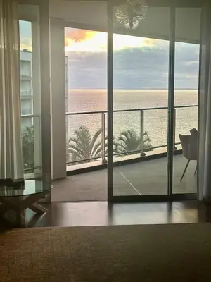a living room with a view of the ocean at Madeira Palace Ocean View in Funchal