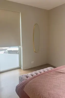 a bedroom with a bed and a mirror on the wall at Madeira Palace Ocean View in Funchal