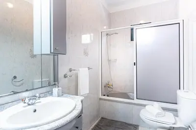 a bathroom with a sink and a toilet and a shower at Estrela House I Calheta Madeira in Calheta