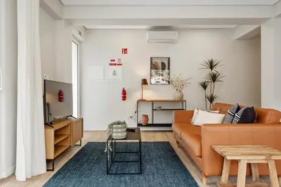 a living room with a couch and a table at Modern Flat Just Steps From Shore in Ponta do Sol