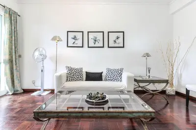 a living room with a white couch and a table at City Centre - Savoy District Funchal in Funchal
