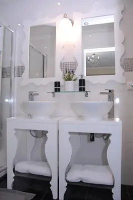 a white bathroom with a sink and a tub at City Centre - Savoy District Funchal in Funchal