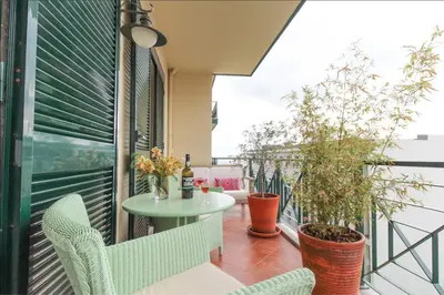 a balcony with a table and chairs and plants at City Centre - Savoy District Funchal in Funchal