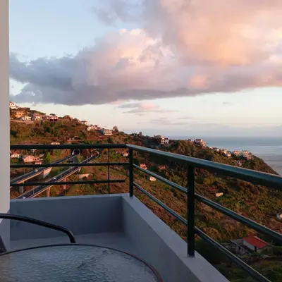 a balcony with a table and a view of the ocean at Yellow Owl II - Bedroom III in Campanário