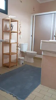 a bathroom with a toilet and a sink at Yellow Owl II - Bedroom III in Campanário
