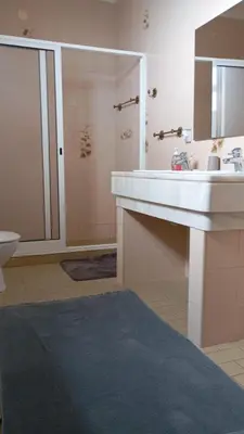 a bathroom with a sink and a shower and a toilet at Yellow Owl II - Bedroom III in Campanário
