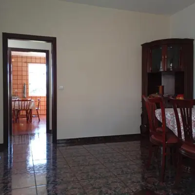 a room with a table and chairs and a white wall at Yellow Owl II - Bedroom III in Campanário