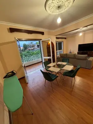 a living room with a table and chairs and a couch at Panoramic Funchal View - 3BR Two-Storey Home in Funchal