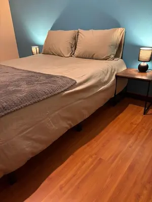 a bed in a room with a wooden floor at Panoramic Funchal View - 3BR Two-Storey Home in Funchal