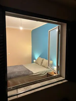 a bedroom with a bed and a window at Panoramic Funchal View - 3BR Two-Storey Home in Funchal