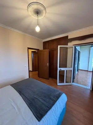 a bedroom with a large bed and a window at Panoramic Funchal View - 3BR Two-Storey Home in Funchal