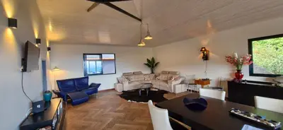 a living room with a couch and a table at Villa da Rochinha - Luxusapartment mit Atlantikblick in São Roque do Faial