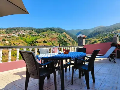 a table and chairs on a balcony with a view at Da Flat in Calheta