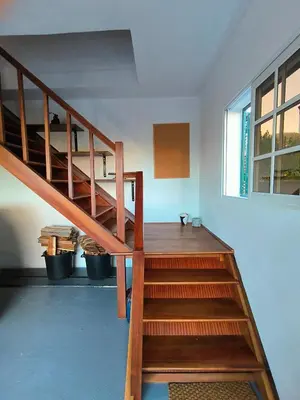 a wooden staircase in a room with a window at Da Flat in Calheta