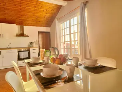 a kitchen with a glass table with dishes on it at Da Flat in Calheta