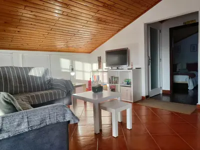 a living room with a couch and a table at Da Flat in Calheta