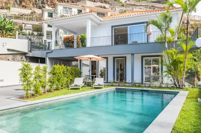 an image of a villa with a swimming pool at Modern Apartment Steps From Beach in Ponta do Sol