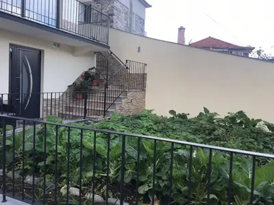 a balcony with a fence and a staircase with plants at Vivenda Silva in Seixal