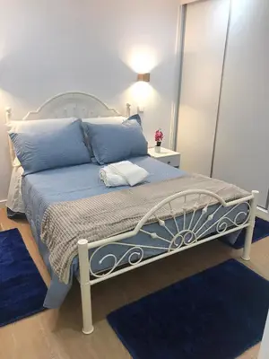 a bedroom with a bed with a large mirror at Vivenda Silva in Seixal