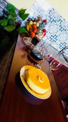 a wooden table with a plate of fruit on it at Sea View Villa in Calheta
