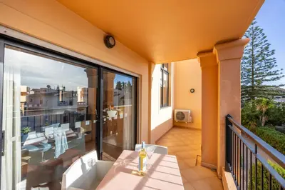 a balcony with a table and a view at Baia da Luz - Upper Luz Suite in Luz