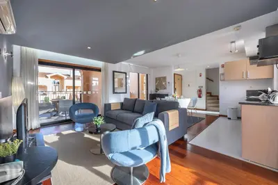 a living room and kitchen with a couch and chairs at Baia da Luz - Upper Luz Suite in Luz