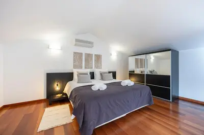 a bedroom with a large bed with two pillows on it at Baia da Luz - Upper Luz Suite in Luz