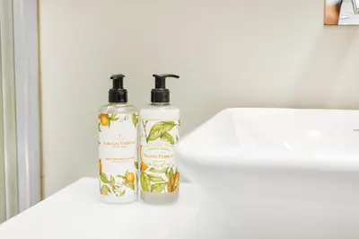 two bottles of soap sitting on a white sink at Premium Avenue Two Bedrooms Apt in Funchal