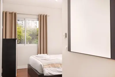 a bedroom with a bed and a mirror at Premium Avenue Two Bedrooms Apt in Funchal