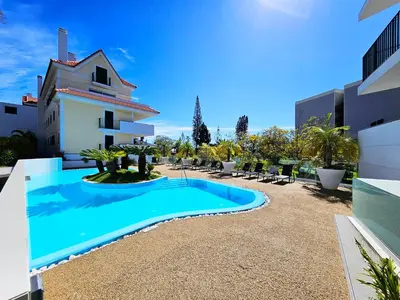 a swimming pool in front of a building at Premium Avenue Two Bedrooms Apt in Funchal