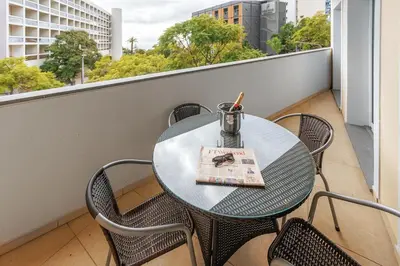 a table on a balcony with a book on it at Premium Avenue Two Bedrooms Apt in Funchal