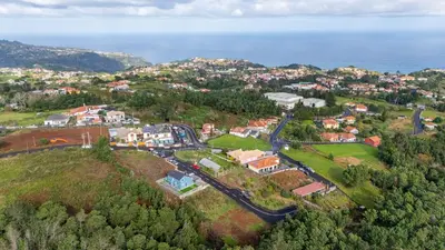 an aerial view of a town on a hill next to the ocean at Santana Trail House - Pico Ruivo in Santana