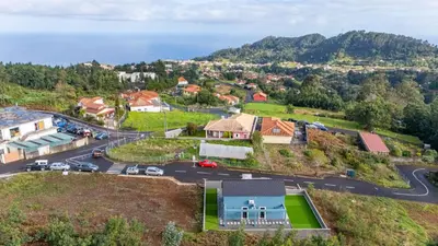 an aerial view of a house with a parking lot at Santana Trail House - Pico Ruivo in Santana