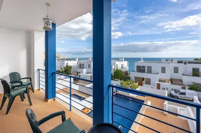 a dining room and living room with a table and chairs at Lote 14 Fontainhas in Luz