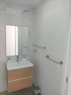 a white bathroom with a sink and a mirror at Villa Atlantic Lodjadis in Gaula