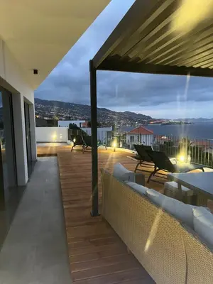 a balcony with couches and a view of the ocean at Villa Atlantic Lodjadis in Gaula