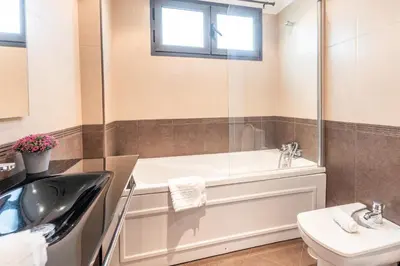 a bathroom with a tub and a sink and a toilet at Apartamento Ruby in Machico