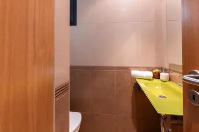 a bathroom with a yellow sink and a toilet at Apartamento Ruby in Machico