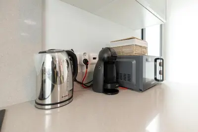 a kitchen counter with a toaster and a microwave at Apartamento Ruby in Machico