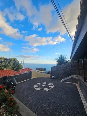 a view of the ocean from a house at Villa Barros in Câmara de Lobos