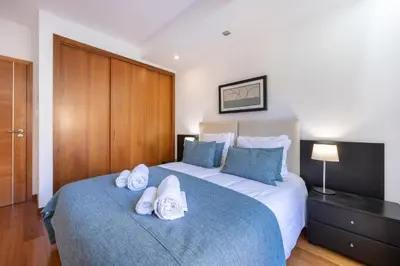 a bedroom with a large bed with towels on it at Baia da Luz - Luz Suite in Luz
