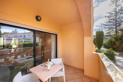 a dining room with a table and a large window at Baia da Luz - Luz Suite in Luz