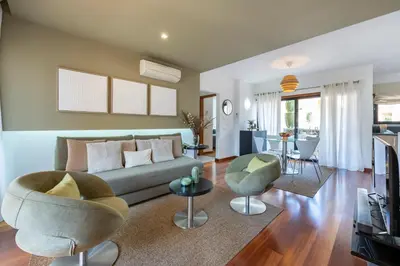 a living room with a couch and chairs at Baia da Luz - Luz Suite in Luz