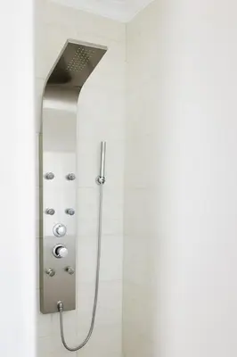 a shower with a shower head in a bathroom at Surf & Yoga Retreats Portugal in Aljezur