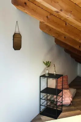 a black table in a room with a wooden ceiling at Surf & Yoga Retreats Portugal in Aljezur